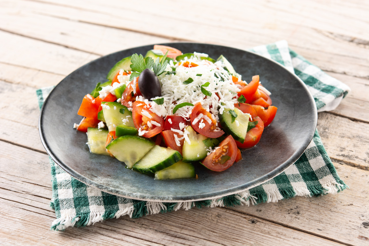 traditional bulgarian shopska salad with tomatocucumber bulgarian sirene cheese wooden table