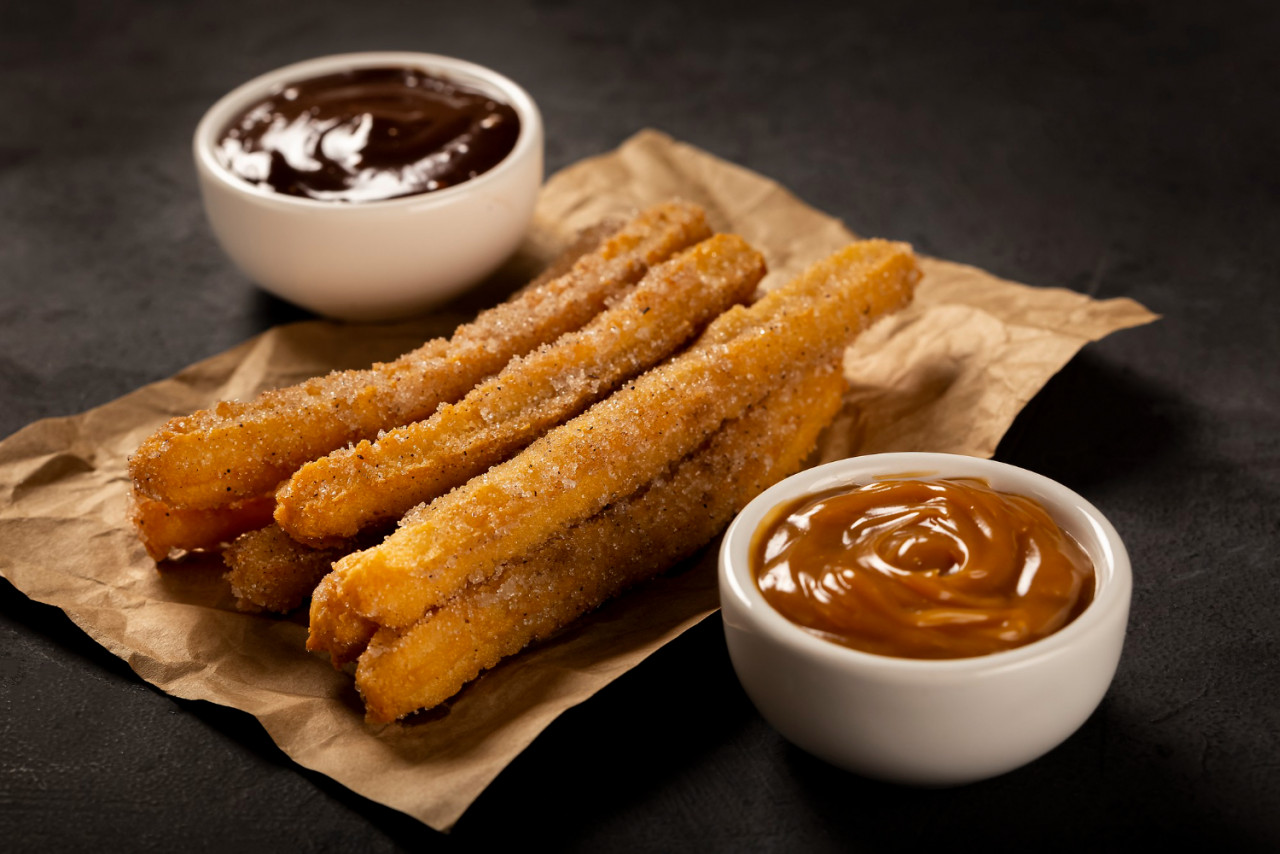 traditional churros with sugar dulce de leche chocolate sauce