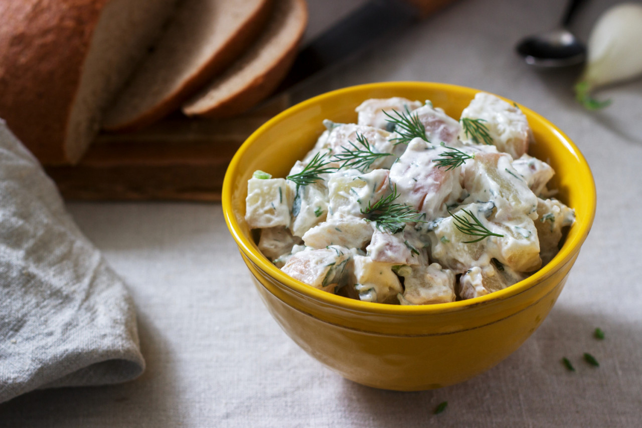 traditional cold potato salad with onions herbs linen tablecloth background rustic style