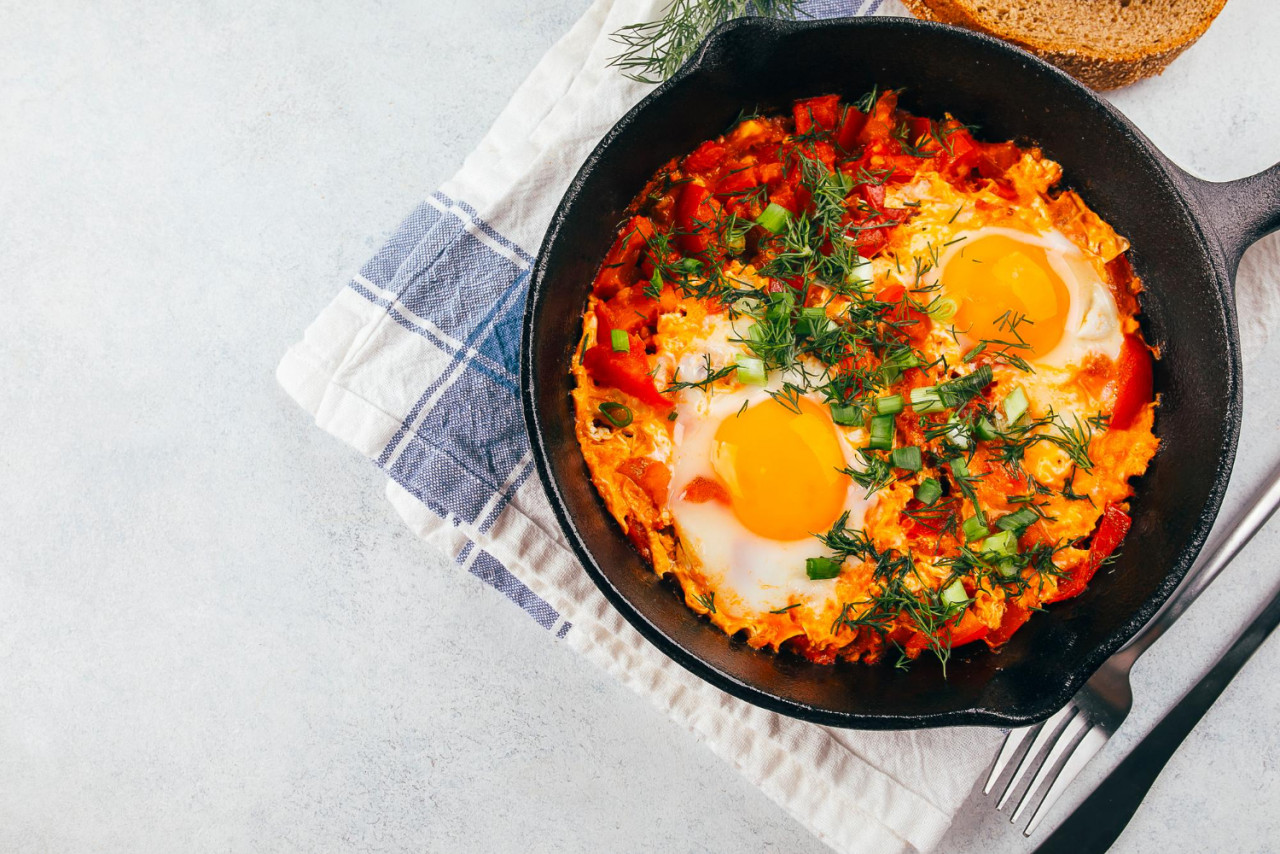 traditional israel dish eggs with tomatoes dish shakshouka pan light table top view copy space