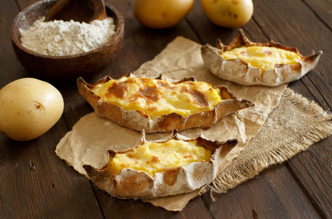 traditional karelian pasties with potatoes wooden table