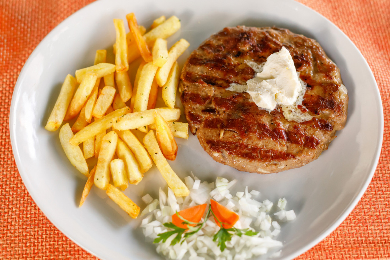 traditional serbian pljeskavica served with french fries