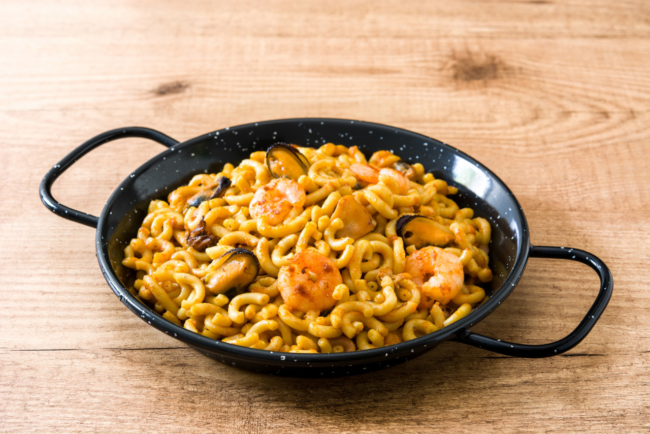 traditional spanish fideua noodle paella wooden table