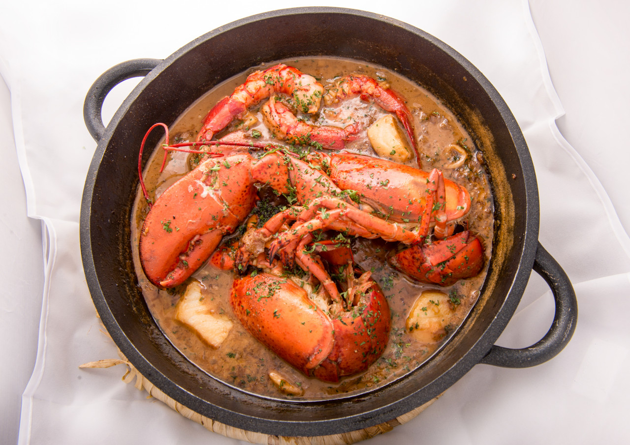 traditional spanish paella rice with lobster meat pan