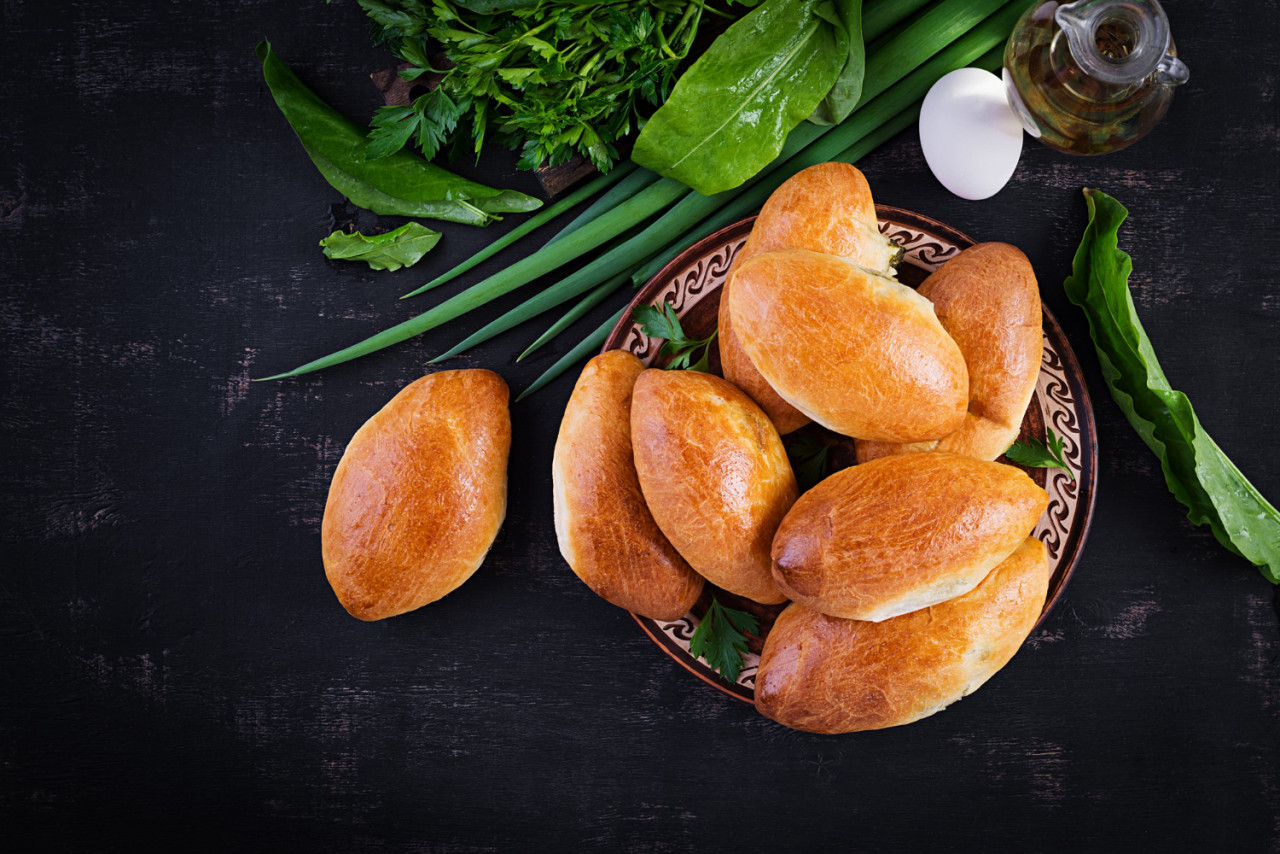 traditional ukrainian pies with eggs green onion sorrel dark background russian piroshki homemade baked patties top view copy space