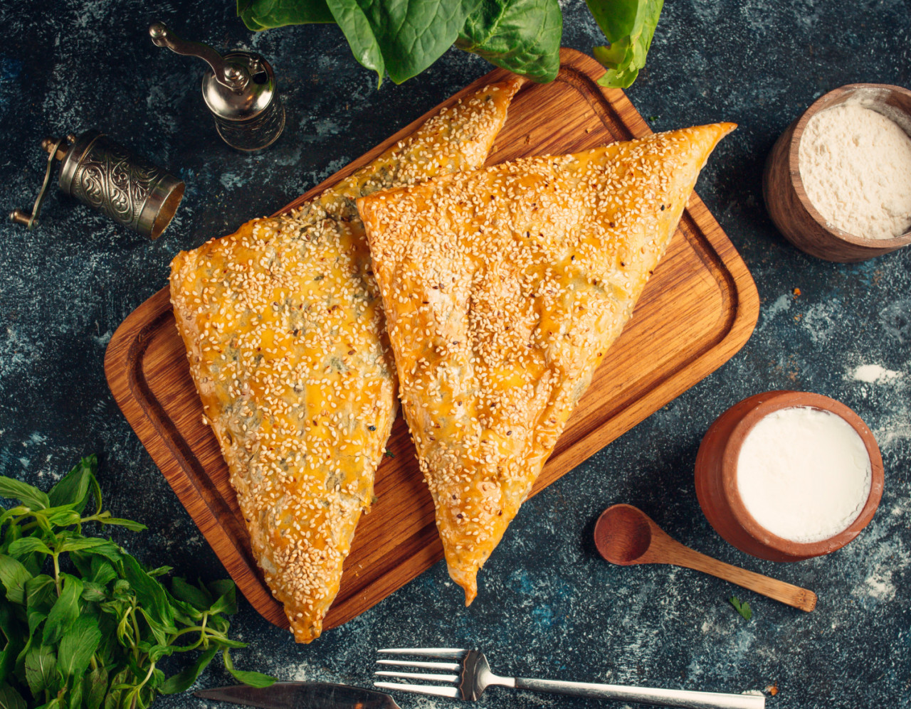 triangled shape bourekas baked pie with sesame seeds