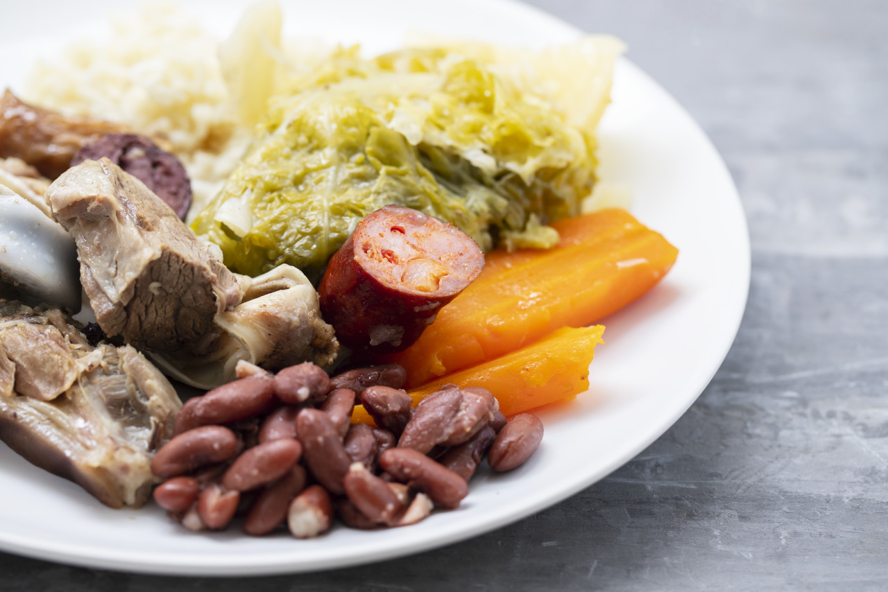 typical portuguese dish boiled meat smoked sausages vegetables rice white plate