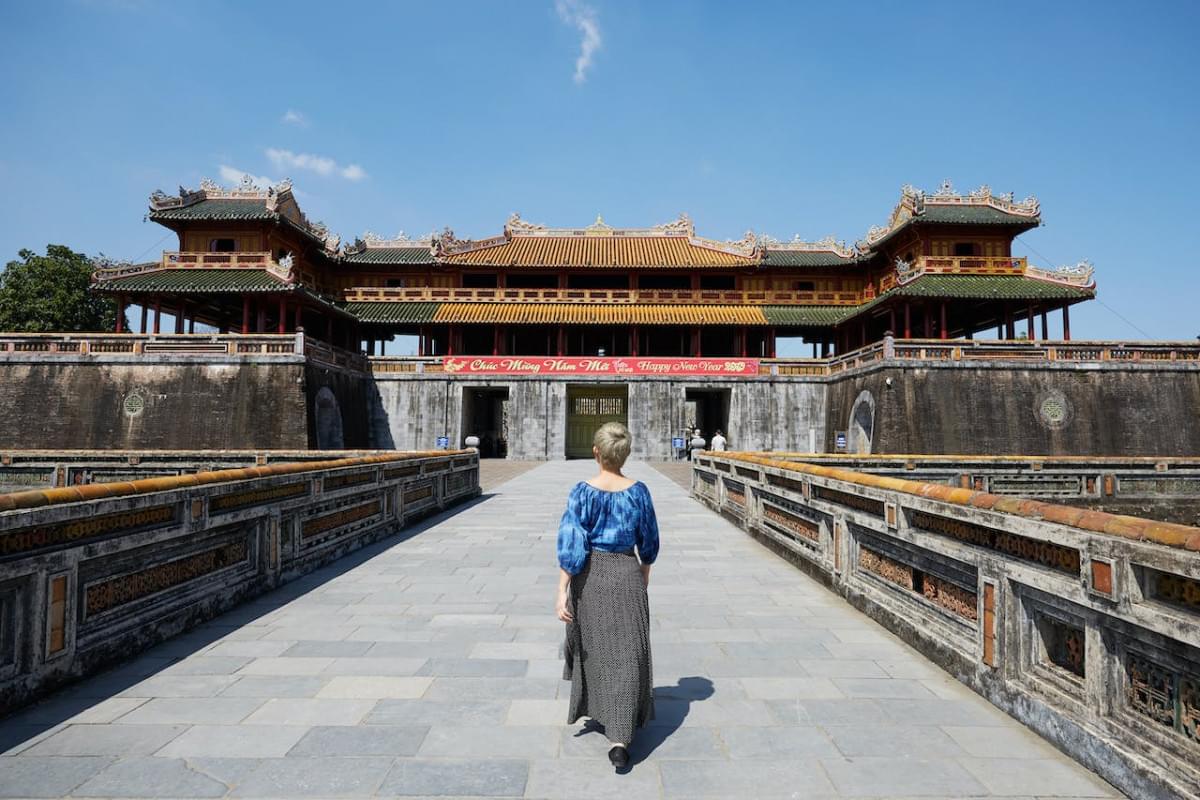 unrecognizable woman walking near meridian gate in vietnam