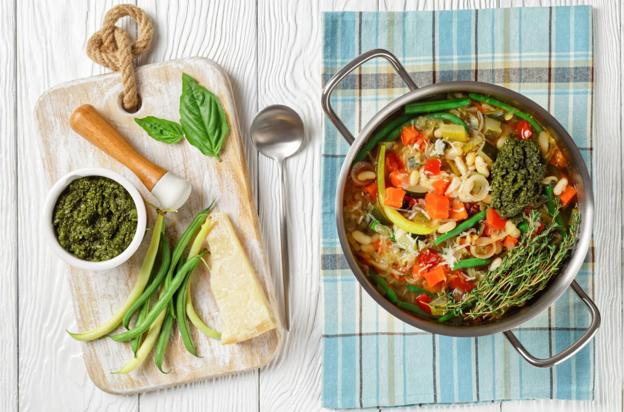 vegetarian summer soupe au pistou french vegetable bean soup with sauce pesto herbs metal pot white wooden table with ingredients flat lay