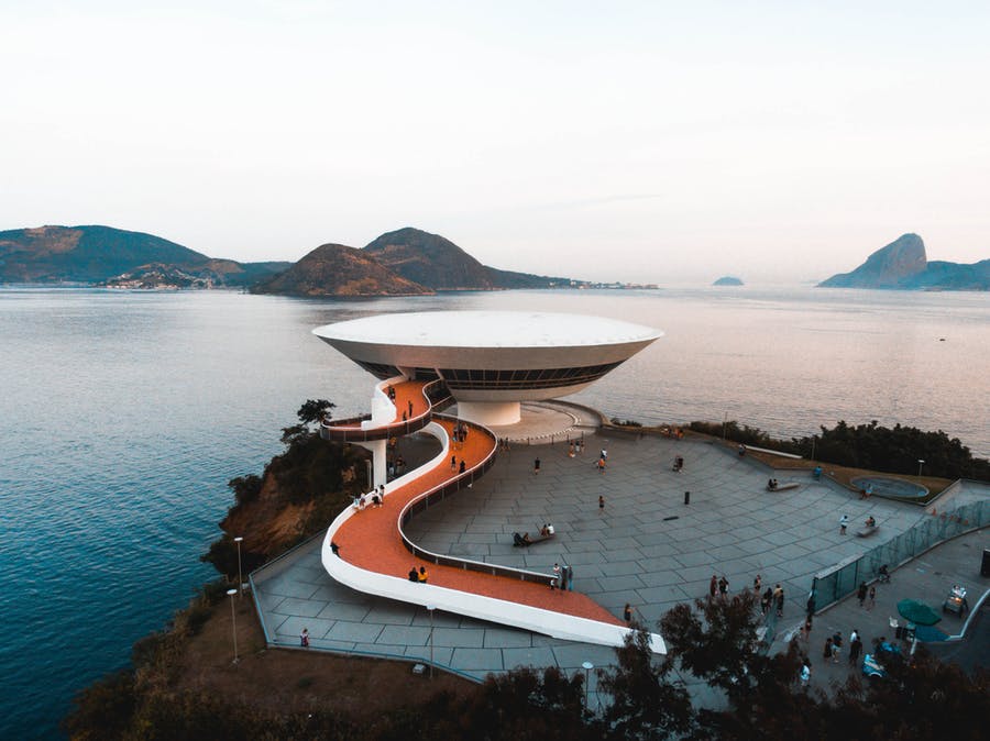 white concrete building beside body of water