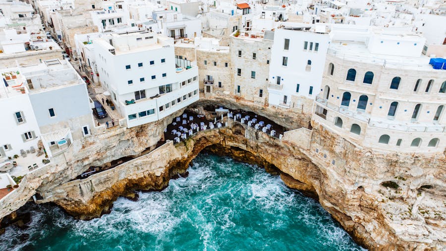 white walls of buildings and hotel on sea shore in polignano a mare in italy 1
