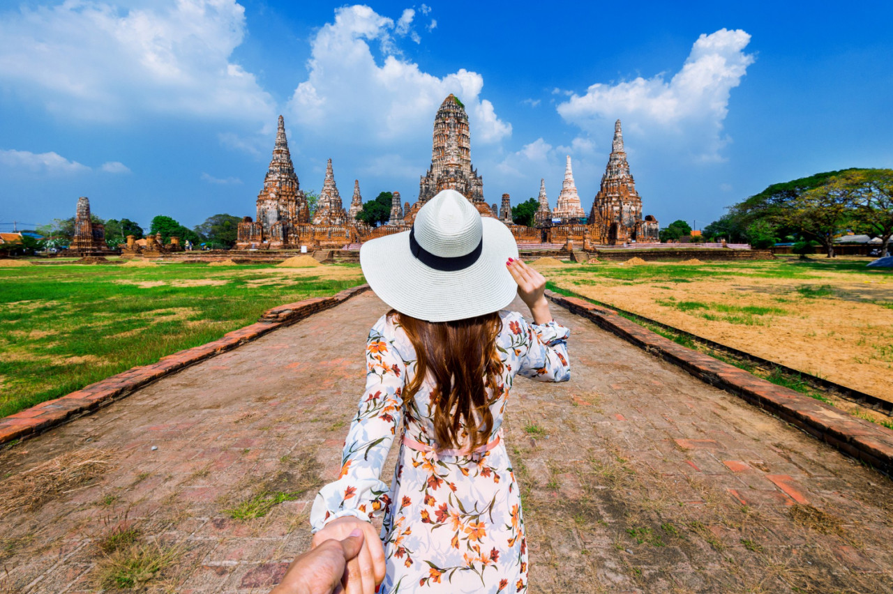 woman holding man s hand leading him ayutthaya historical park wat chaiwatthanaram buddhist temple thailand
