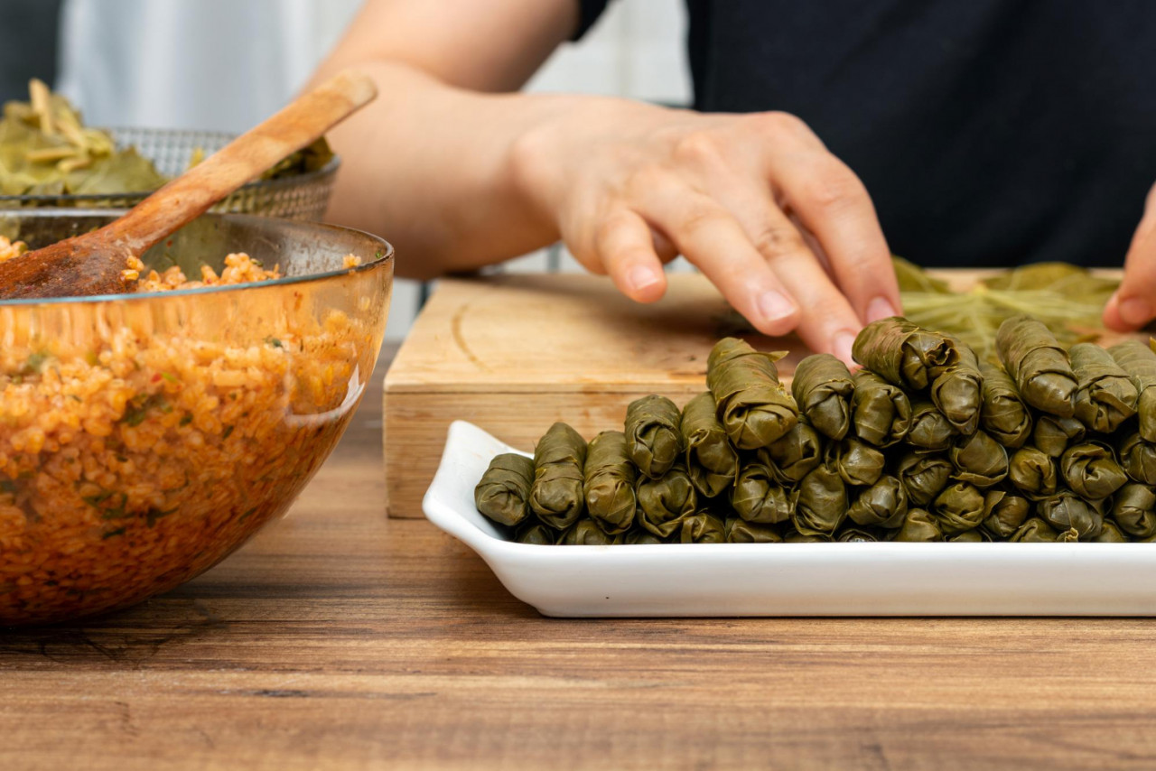 woman preparing turkish sarma in kitchen