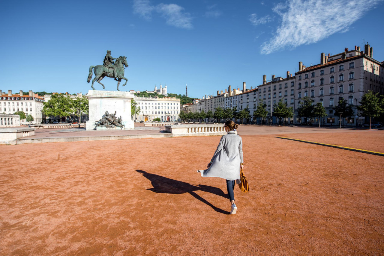 woman walking famous bellecour square with louis king statue traveling lyon city france