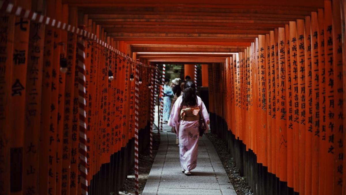 woman walking in torii gates 2