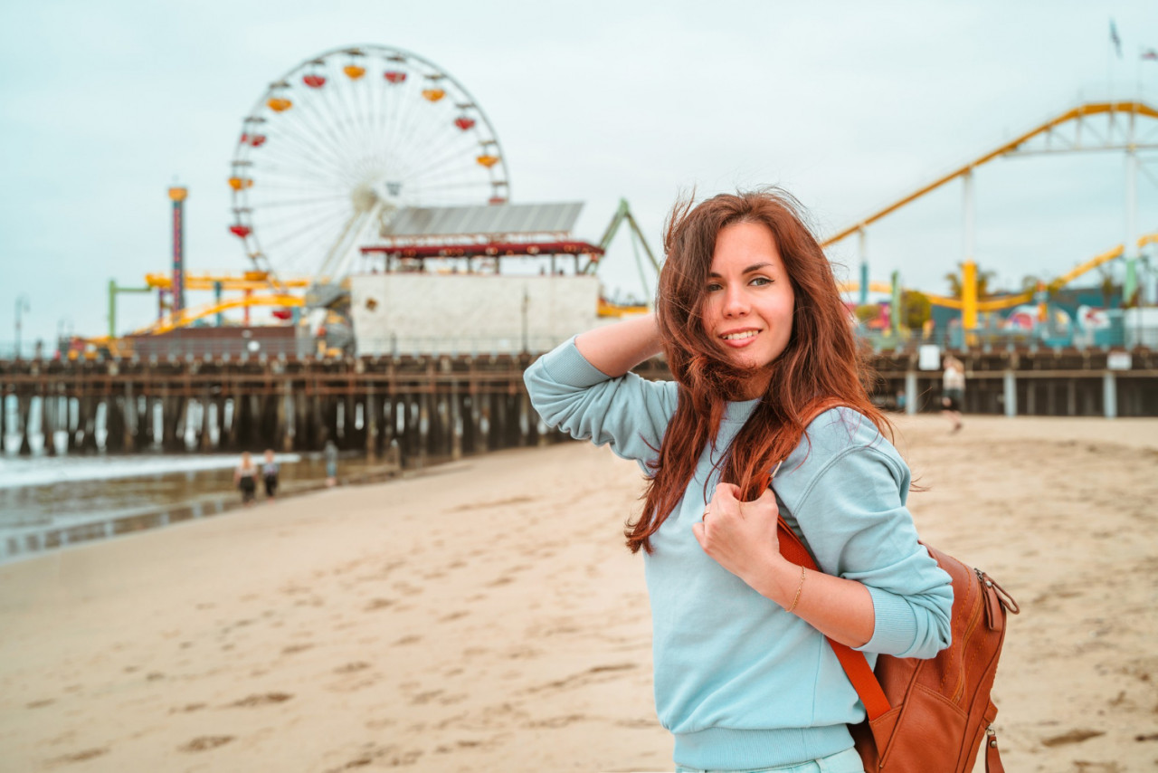 young woman purple pullover santa monica beach los angeles